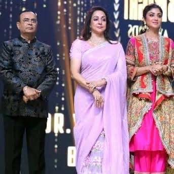 Yogesh Lakhani on stage at an awards ceremony alongside other guests