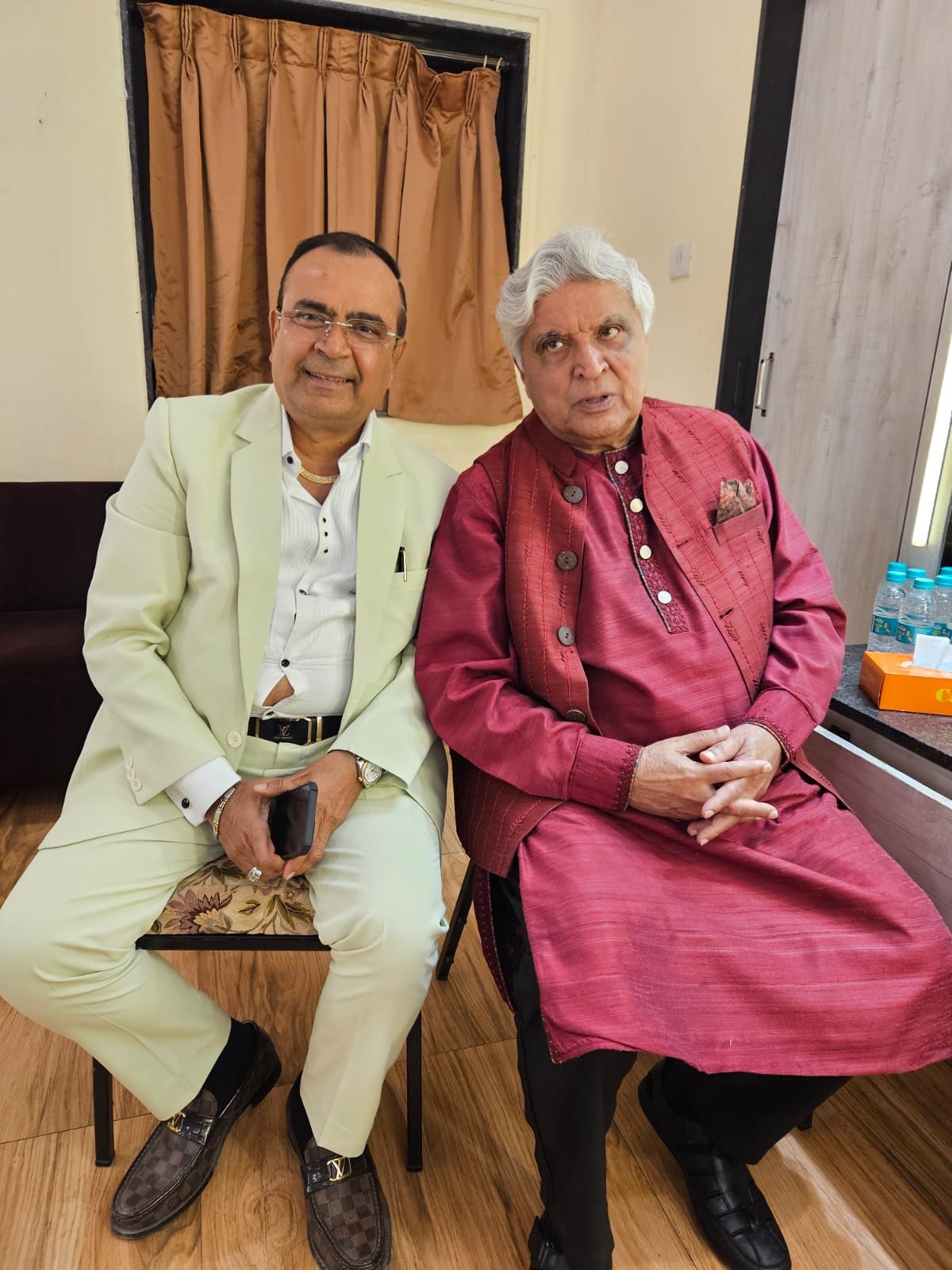 Yogesh Lakhani in conversation with a fellow guest backstage at a Mumbai event